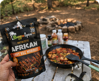 A pouch of Reggae Spice marinade held near a campsite meal
